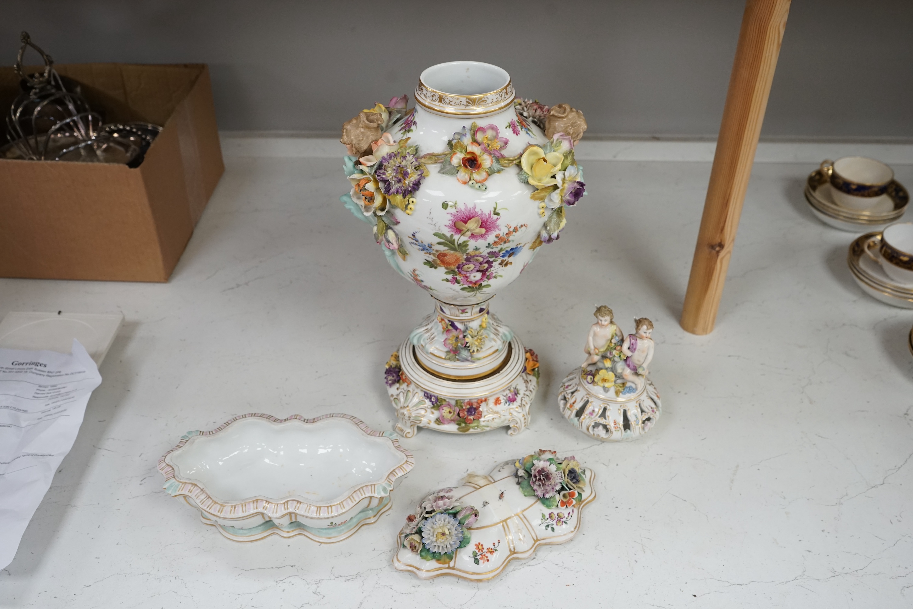 A Dresden floral encrusted porcelain incense burner hand painted with figures annd flowers, together with a similar lidded box, largest 52cm high. Condition - some losses